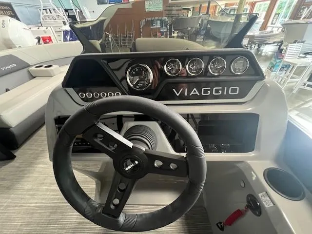 Slide: The Image of 2025 Viaggio Lago V 18 boat dashboard with steering wheel and gauges. - 12