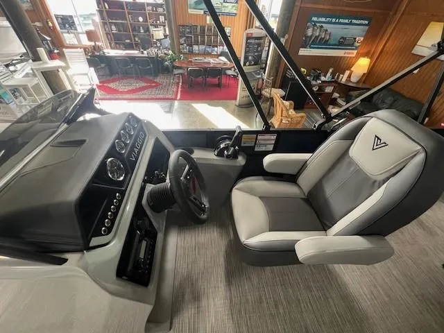Slide: The Image of 2025 Viaggio Lago V 18 boat interior with modern helm and comfortable seating. - 14