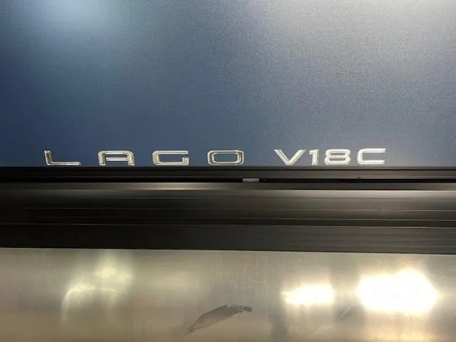 Slide: The Image of Viaggio Lago V18C 2025 model emblem on metallic surface. - 2