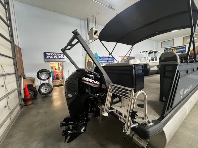 Slide: The Image of 2025 Viaggio Lago V 18 pontoon boat with Mercury outboard motor in showroom. - 4