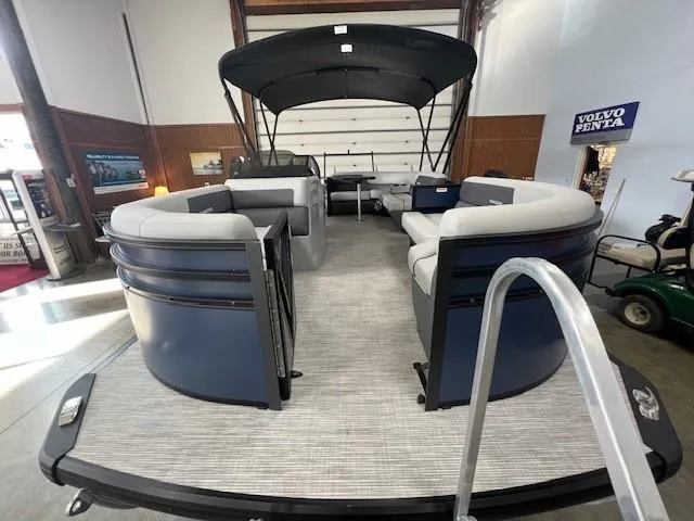 Slide: The Image of 2025 Viaggio Lago V 18 pontoon boat with spacious seating and canopy in showroom. - 7