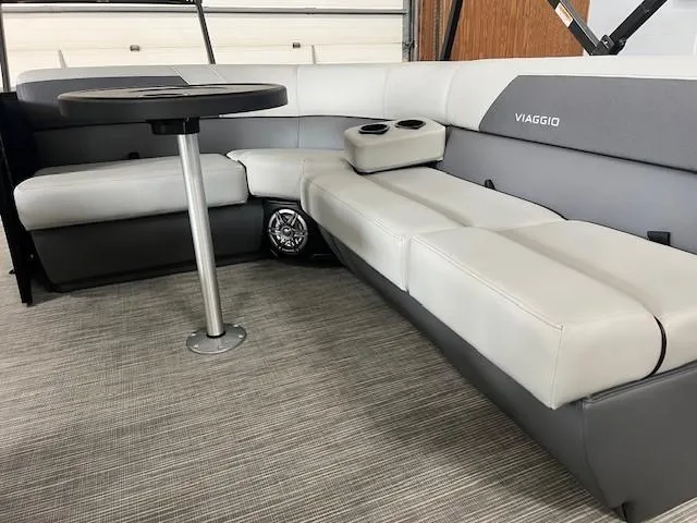 Slide: The Image of 2025 Viaggio Lago V 18 boat interior with gray seating and table. - 9