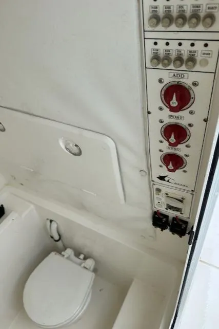 Slide: The Image of 2011 Contender 28 Sport boat interior with control panel and toilet. - 11