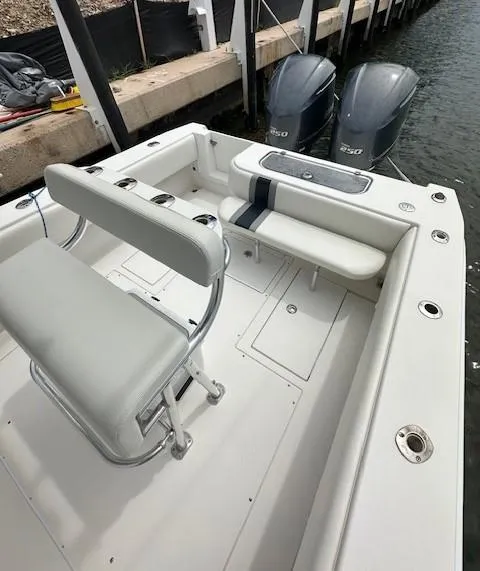 Slide: The Image of 2011 Contender 28 Sport boat with dual engines docked by the water. - 6