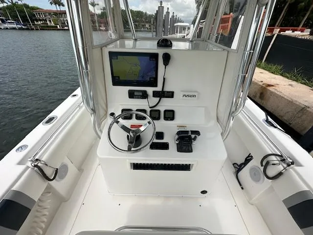 Slide: The Image of 2011 Contender 28 Sport boat cockpit with navigation equipment and steering wheel. - 8