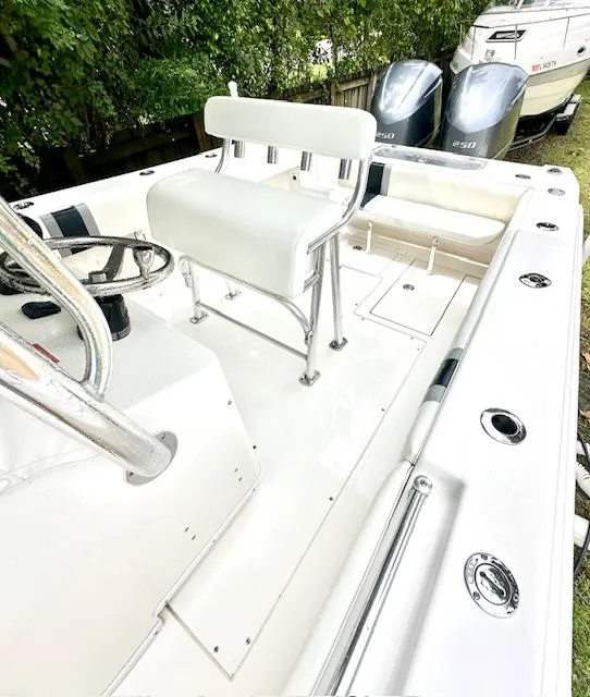 Slide: The Image of 2011 Contender 28 Sport boat interior with seating and dual engines. - 9