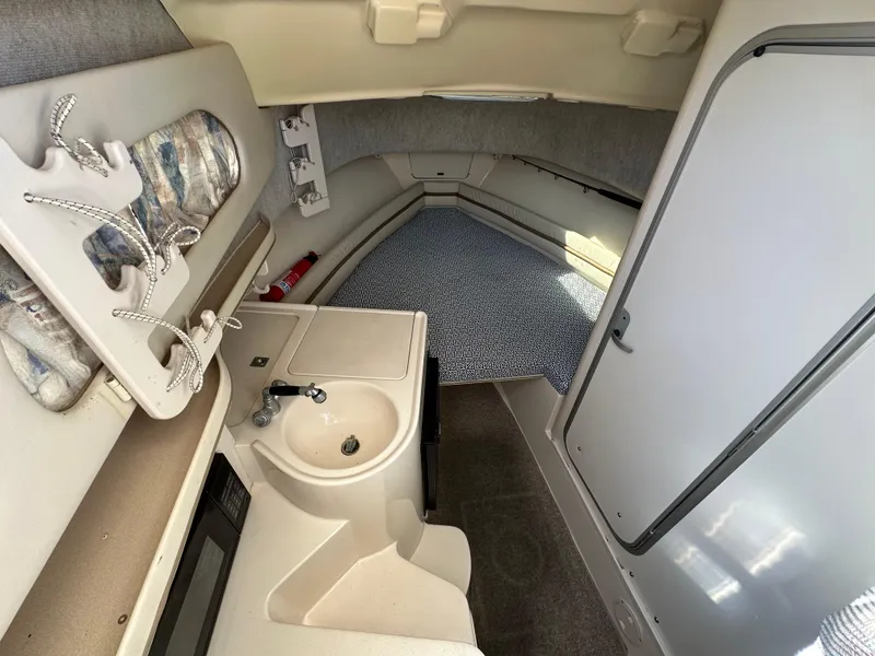 Slide: The Image of 2002 Grady-White 282 Sailfish cabin interior with sink and seating area. - 13