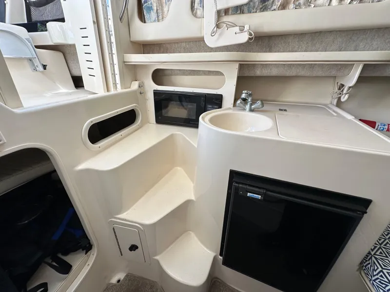 Slide: The Image of Interior of 2002 Grady-White 282 Sailfish boat with kitchenette and storage. - 14
