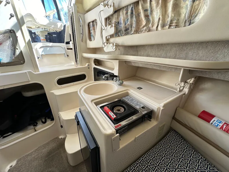 Slide: The Image of 2002 Grady-White 282 Sailfish boat interior with compact kitchen and stove. - 15