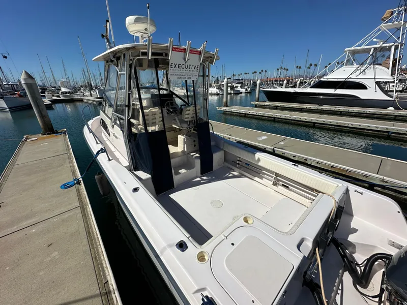 Slide: The Image of 2002 Grady-White 282 Sailfish boat docked in marina under clear blue sky. - 4