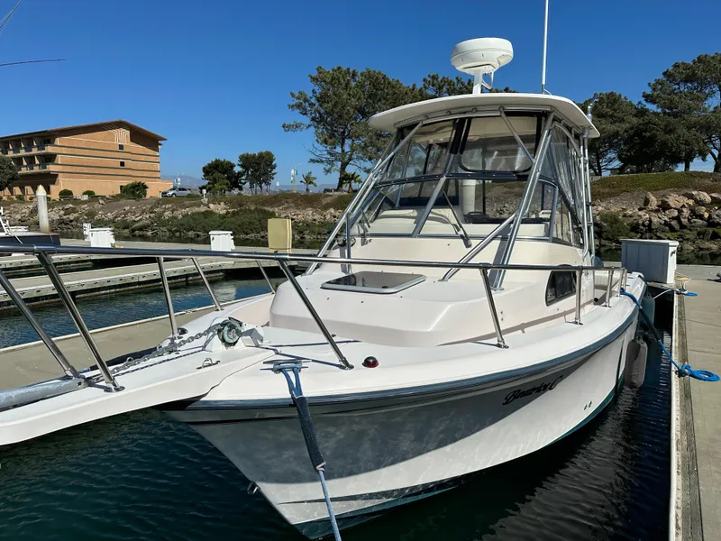 Slide: The Image of 2002 Grady-White 282 Sailfish boat docked in marina under clear sky. - 5