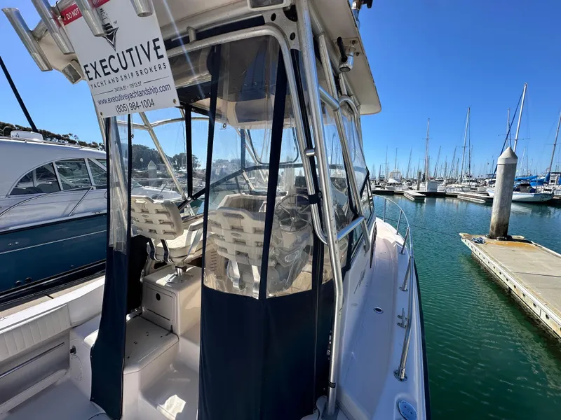 Slide: The Image of 2002 Grady-White 282 Sailfish boat docked in marina, clear blue sky. - 7