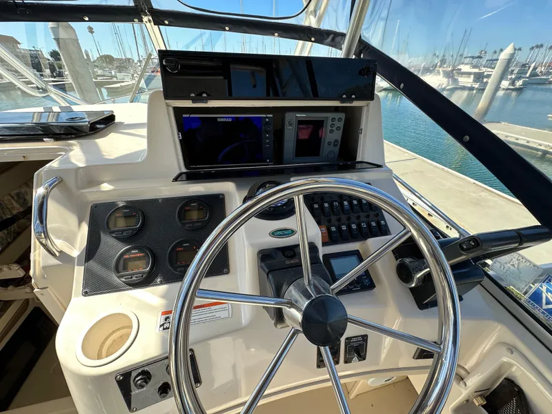 Slide: The Image of 2002 Grady-White 282 Sailfish boat helm with steering wheel and navigation instruments. - 9