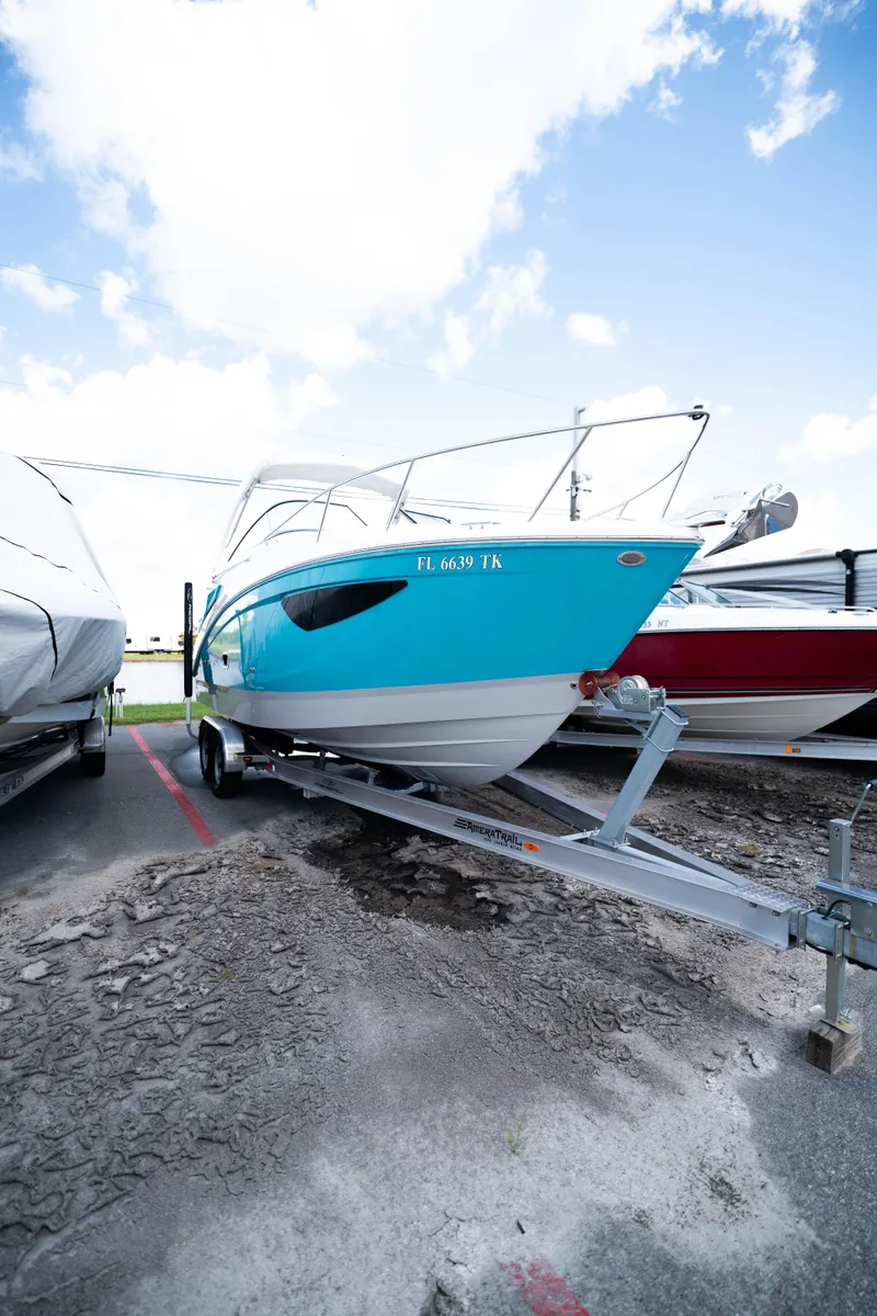 The Image of 2023 Regal 26 XO boat on trailer under blue sky. - 0