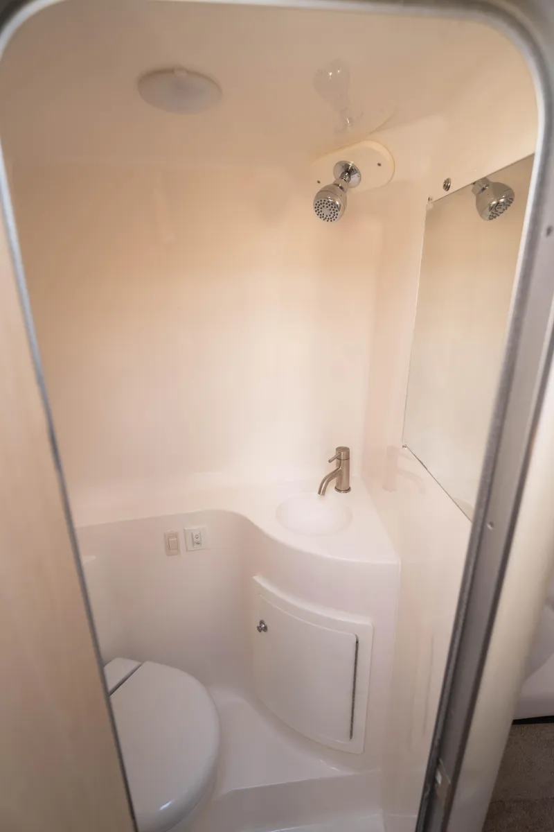 Slide: The Image of 2023 Regal 26 XO boat bathroom with compact design and modern fixtures. - 11