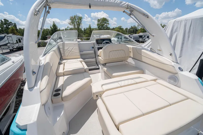 Slide: The Image of 2023 Regal 26 XO boat with spacious seating and modern design under a clear sky. - 15