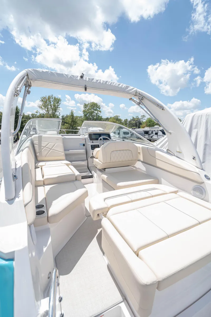 Slide: The Image of 2023 Regal 26 XO boat interior with white seating under a blue sky. - 16