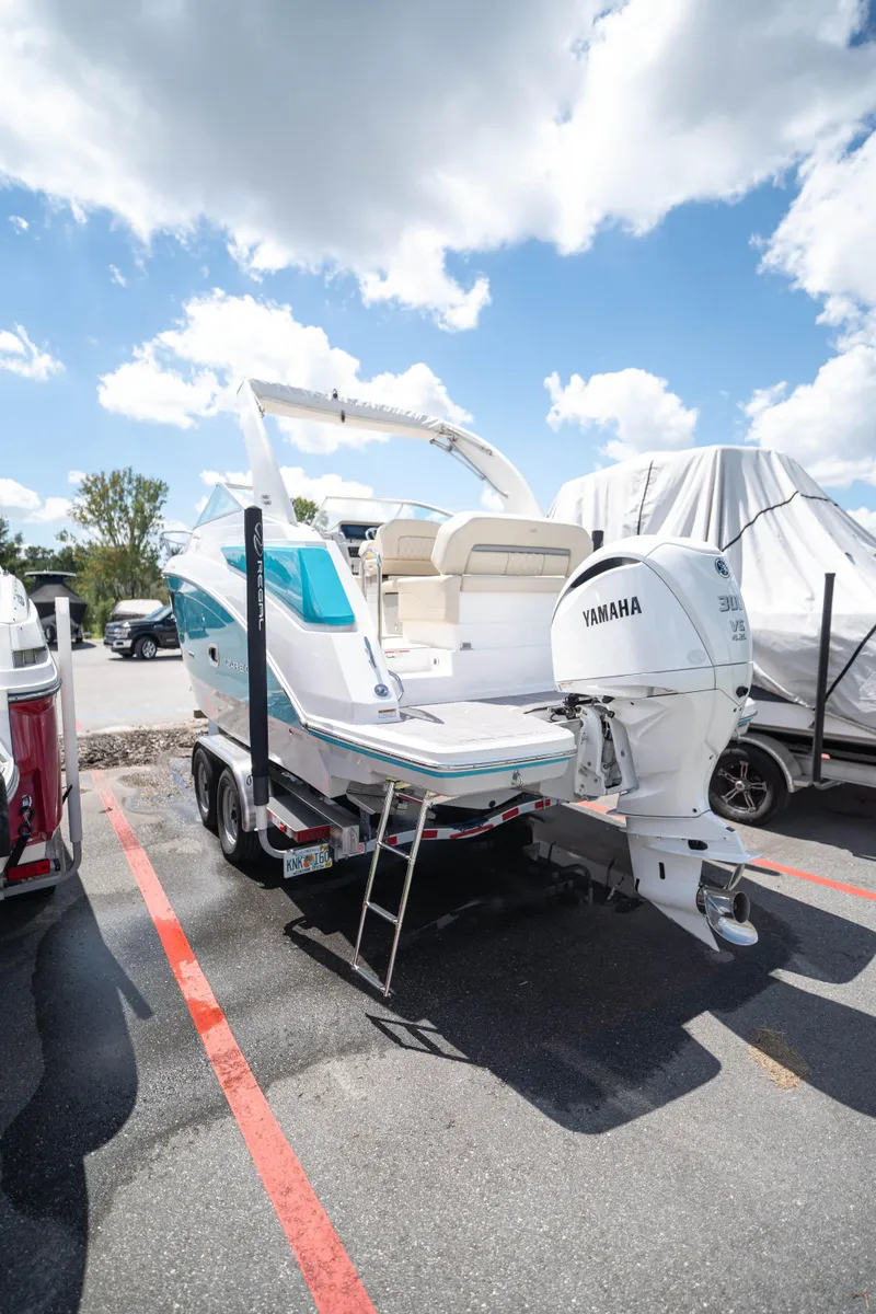 Slide: The Image of 2023 Regal 26 XO boat with Yamaha outboard motor in parking lot. - 17