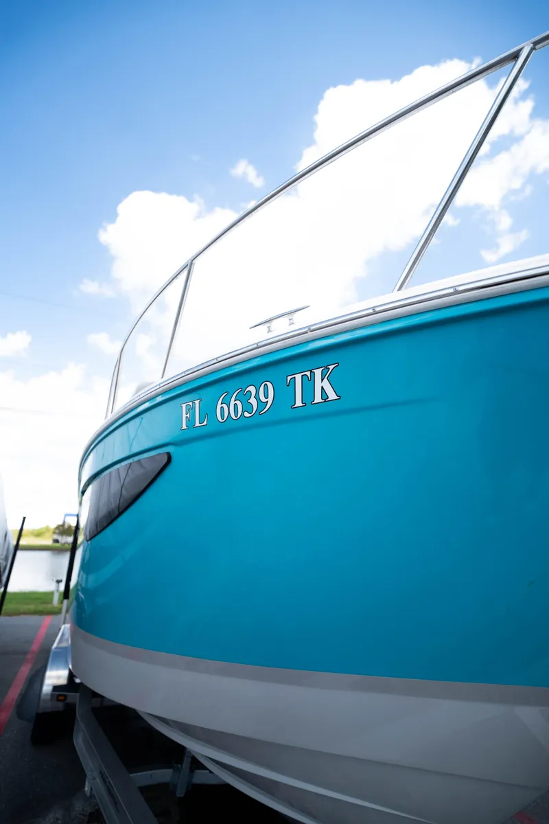 Slide: The Image of 2023 Regal 26 XO boat with blue hull and registration number FL 6639 TK. - 3