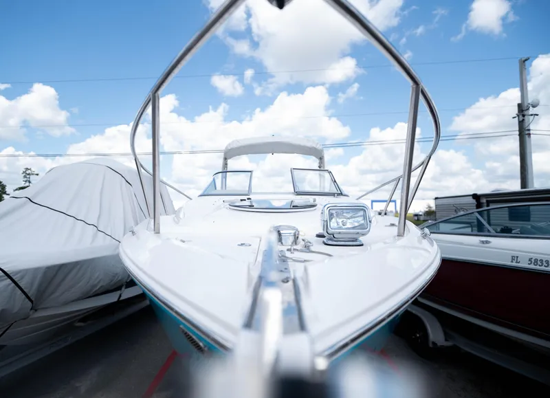 Slide: The Image of 2023 Regal 26 XO boat under a clear blue sky, front view. - 5