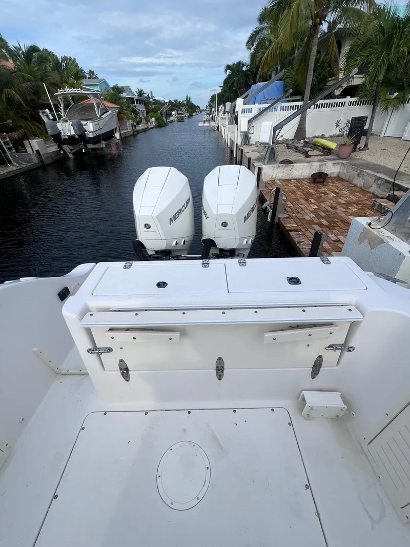 Slide: The Image of 1997 Mako 252 Center Console boat docked in a scenic canal. - 7