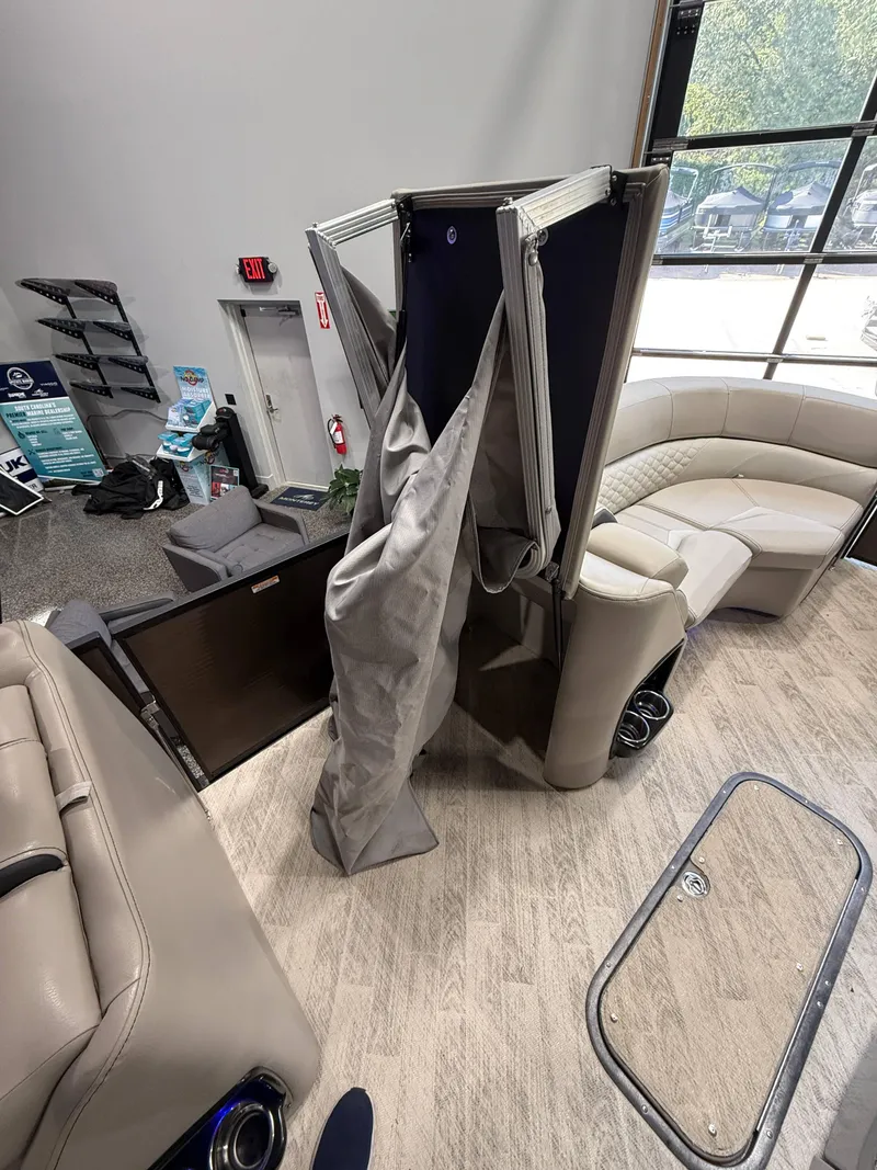 Slide: The Image of 2019 Manitou 25 SES Platinum interior with seating and storage compartments. - 10