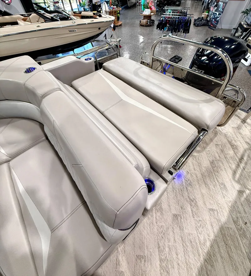 Slide: The Image of 2019 Manitou 25 SES Platinum boat interior with luxurious seating and modern design. - 14