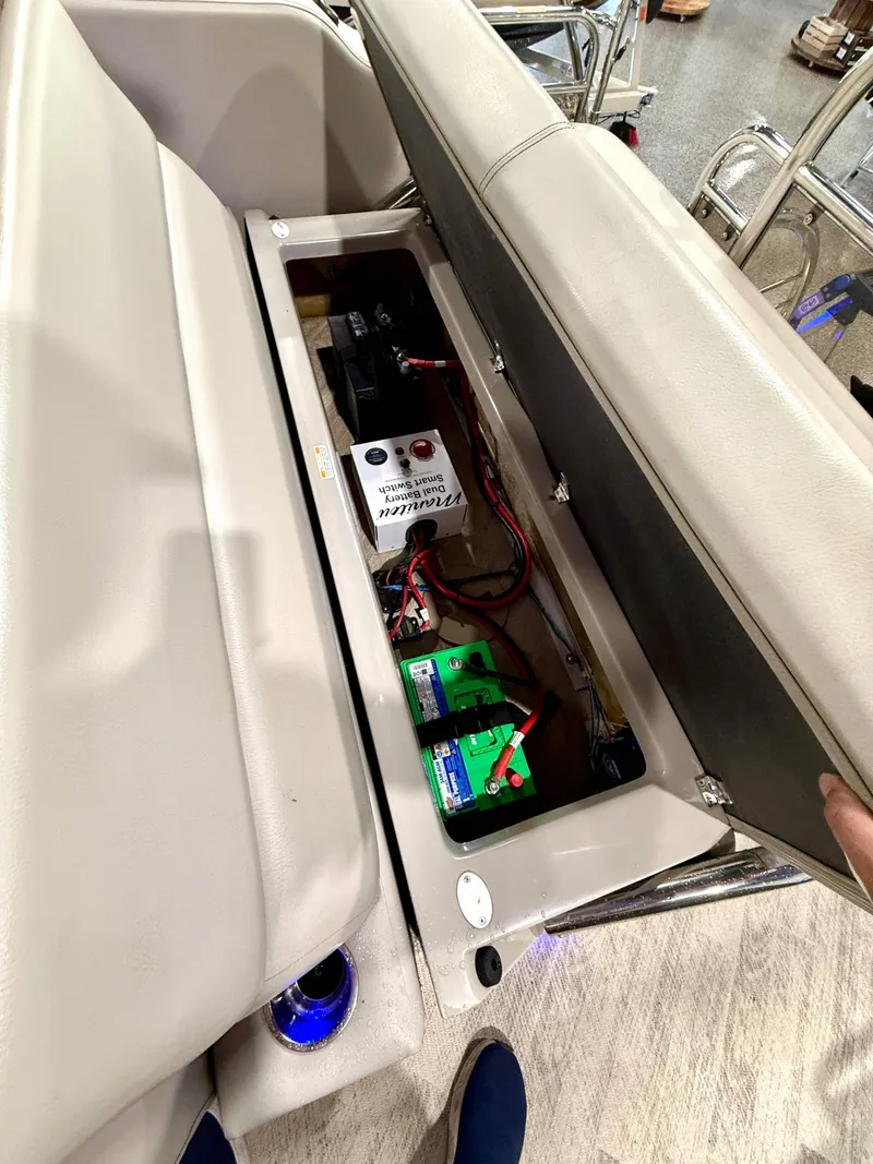 Slide: The Image of 2019 Manitou 25 SES Platinum boat battery compartment with wiring and components. - 17