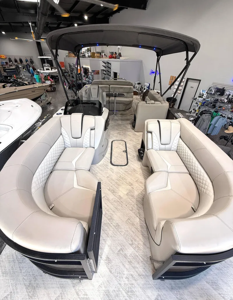 Slide: The Image of 2019 Manitou 25 SES Platinum pontoon boat interior with luxurious seating and canopy. - 3