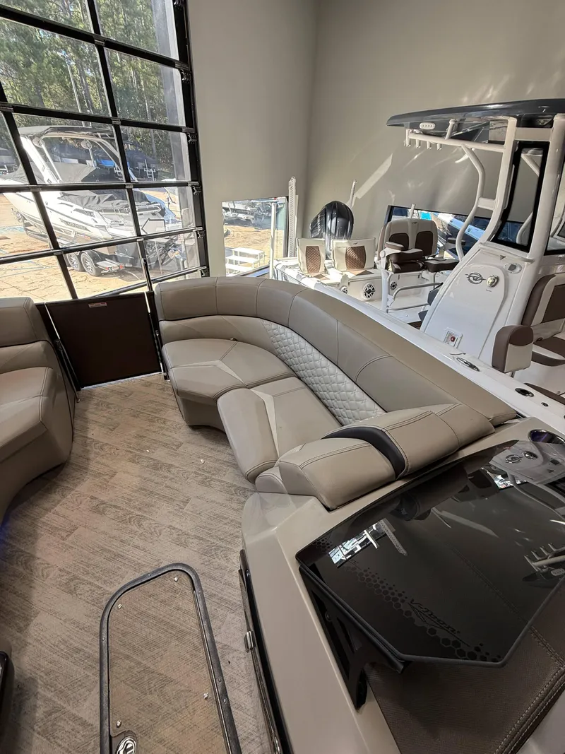 Slide: The Image of 2019 Manitou 25 SES Platinum boat interior with luxurious seating and modern design. - 9