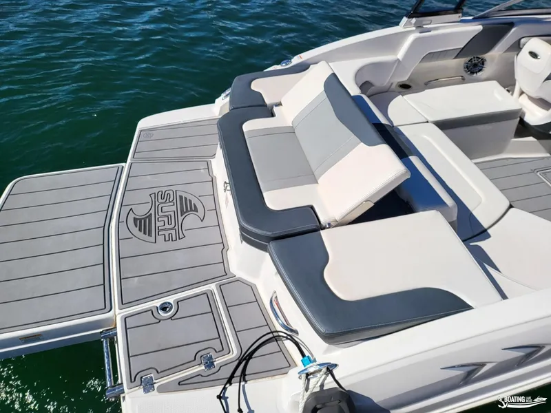 Slide: The Image of 2021 Chaparral 23 Surf boat interior with cushioned seating and swim platform. - 10