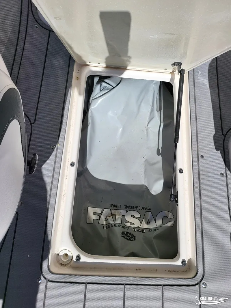 Slide: The Image of 2021 Chaparral 23 Surf boat with open storage compartment and FatSac ballast bag. - 13