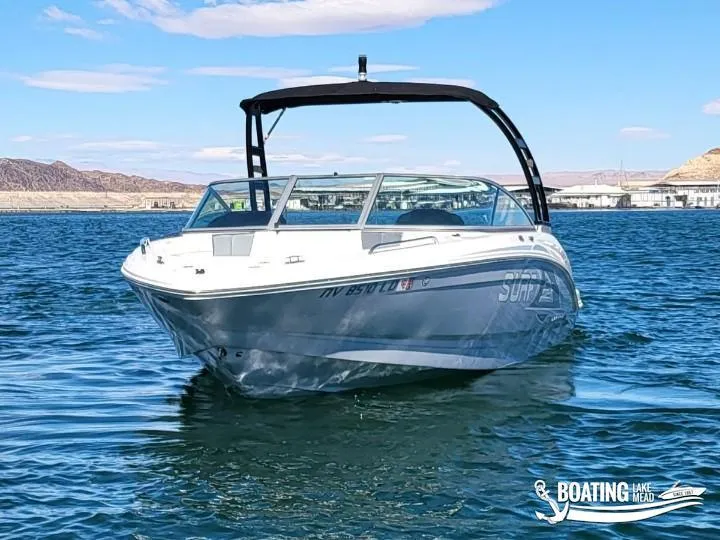Slide: The Image of 2021 Chaparral 23 Surf boat on a lake with clear skies. - 4
