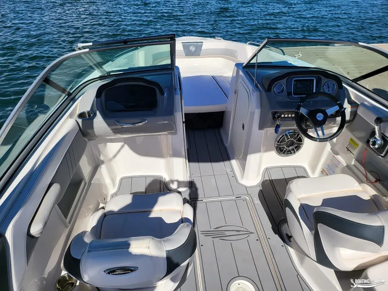 Slide: The Image of 2021 Chaparral 23 Surf boat interior with steering wheel and seating. - 6