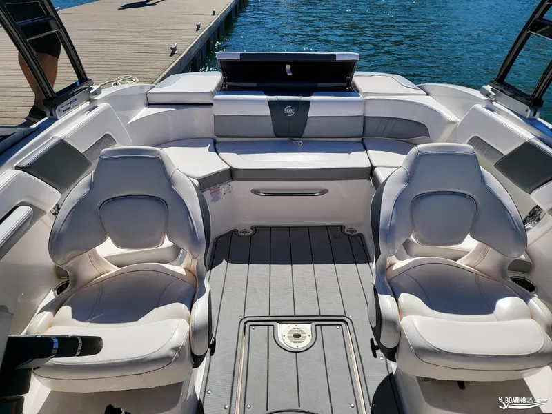 Slide: The Image of 2021 Chaparral 23 Surf boat interior with plush seating and sleek design. - 8