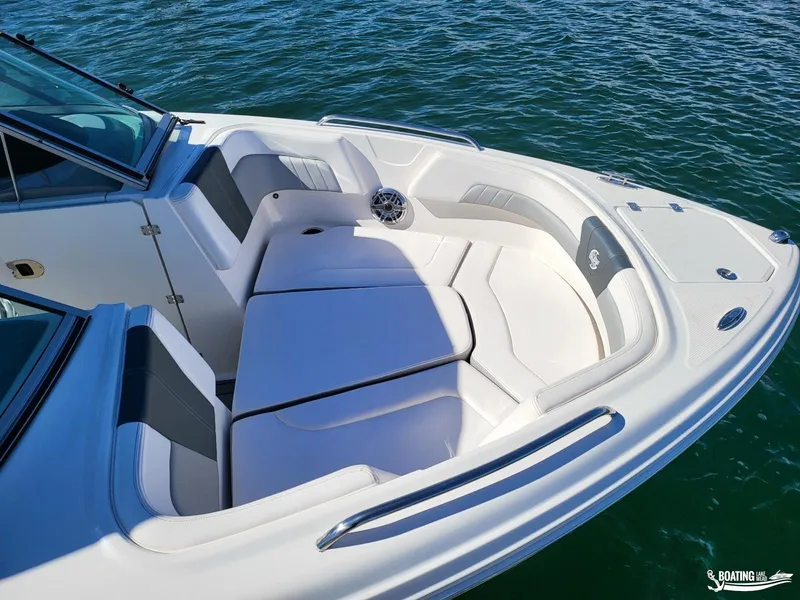 Slide: The Image of 2021 Chaparral 23 Surf boat with spacious seating on calm water. - 9
