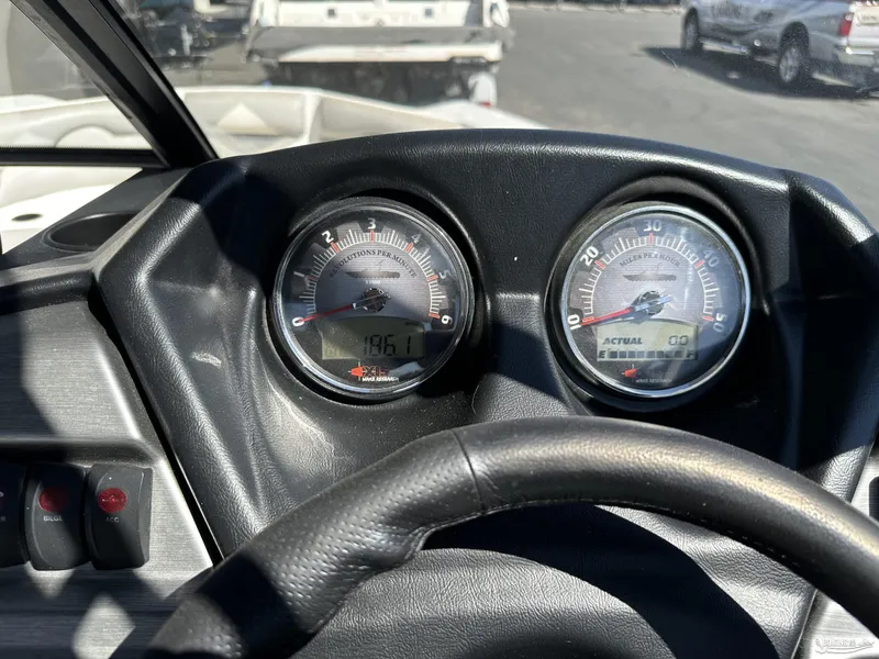Slide: The Image of Close-up of 2012 Axis A22 boat dashboard with gauges and steering wheel. - 11