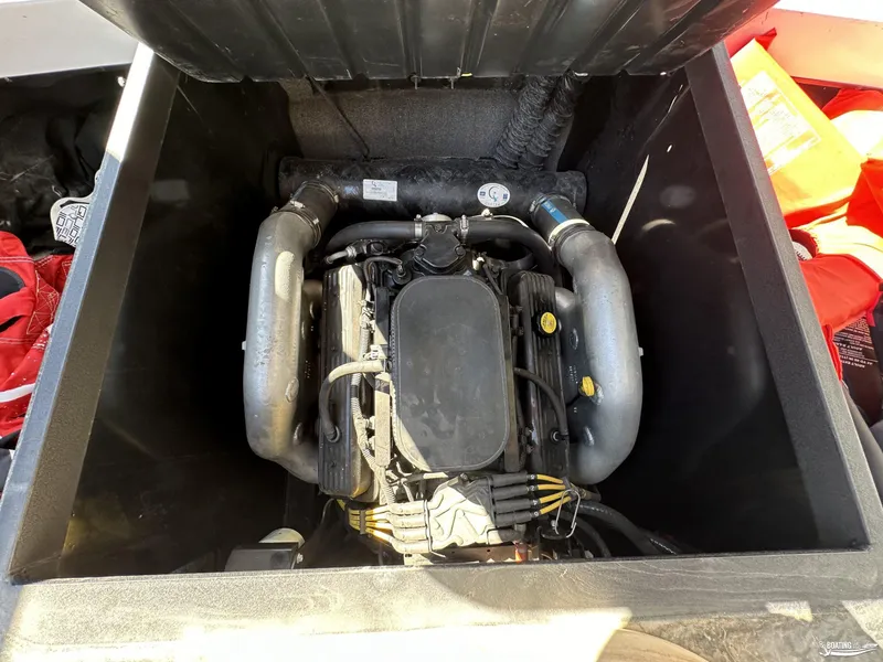 Slide: The Image of 2012 Axis A22 boat engine compartment with visible components and surrounding equipment. - 13