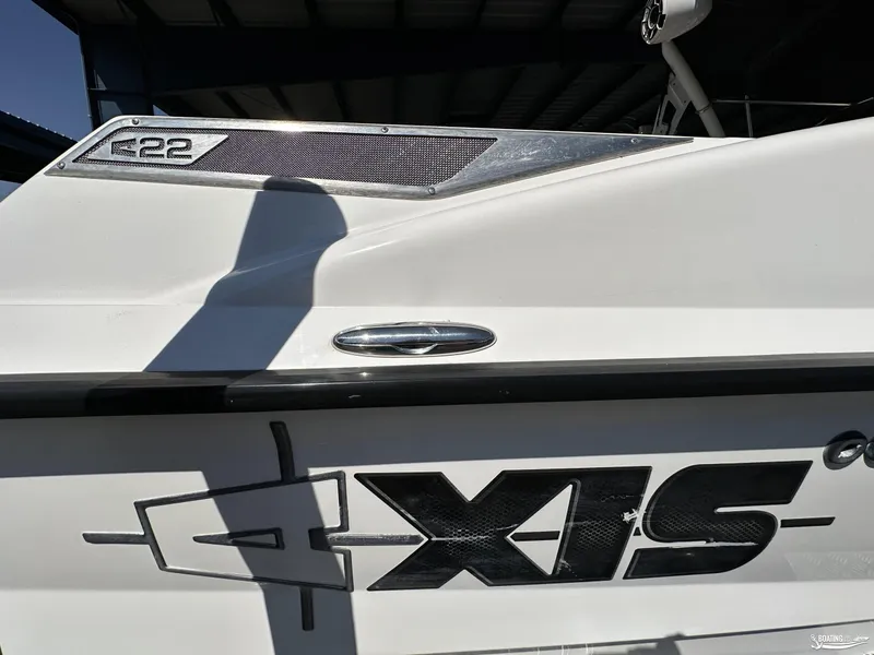 Slide: The Image of 2012 Axis A22 boat with logo and model details in sunlight. - 6