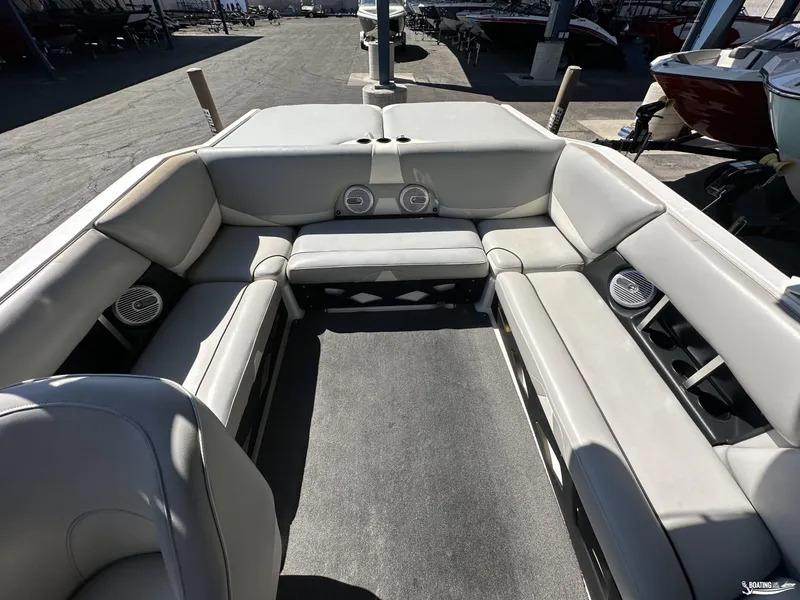 Slide: The Image of 2012 Axis A22 boat interior with spacious seating and built-in speakers. - 7