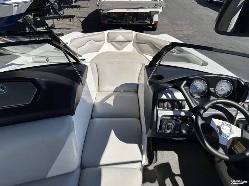Slide: The Image of 2012 Axis A22 boat interior with steering wheel and dashboard controls. - 8