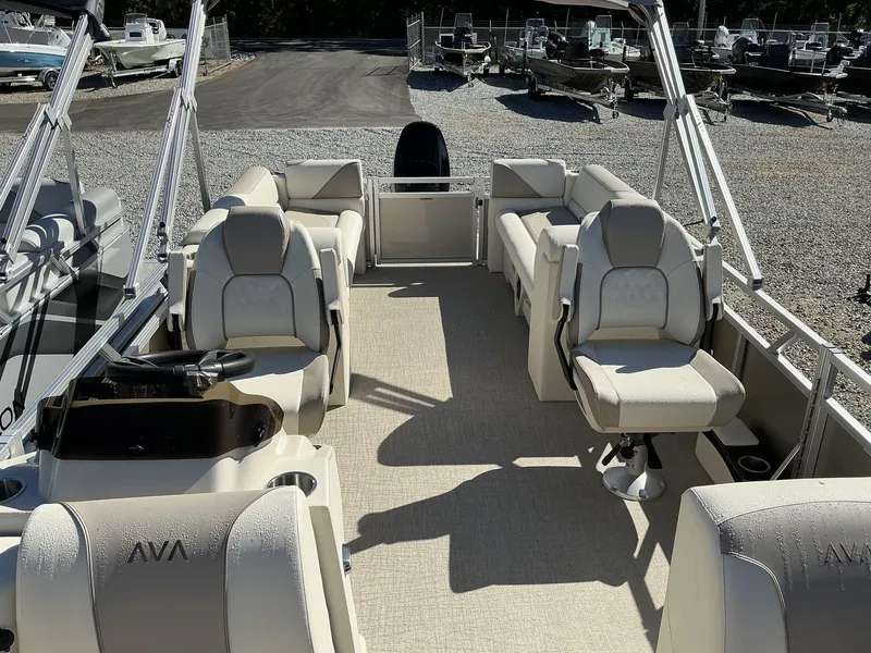 Slide: The Image of 2025 Avalon Venture 23 FT Quad Lounger boat interior with plush seating and steering console. - 3