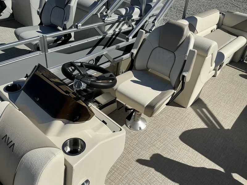 Slide: The Image of 2025 Avalon Venture 23 FT Quad Lounger interior with steering wheel and seating. - 4