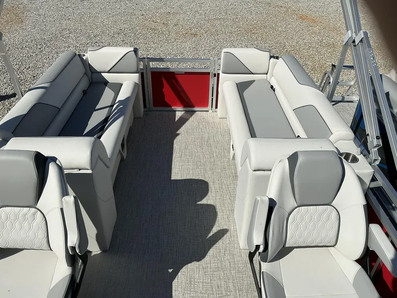 Slide: The Image of 2025 Avalon Venture 23 FT Quad Lounger interior with gray seating and red accents. - 6