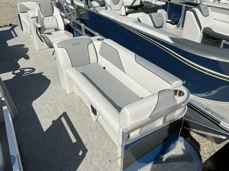 Slide: The Image of 2025 Avalon Venture 21 FT Quad Lounger boat interior with plush seating and modern design. - 3