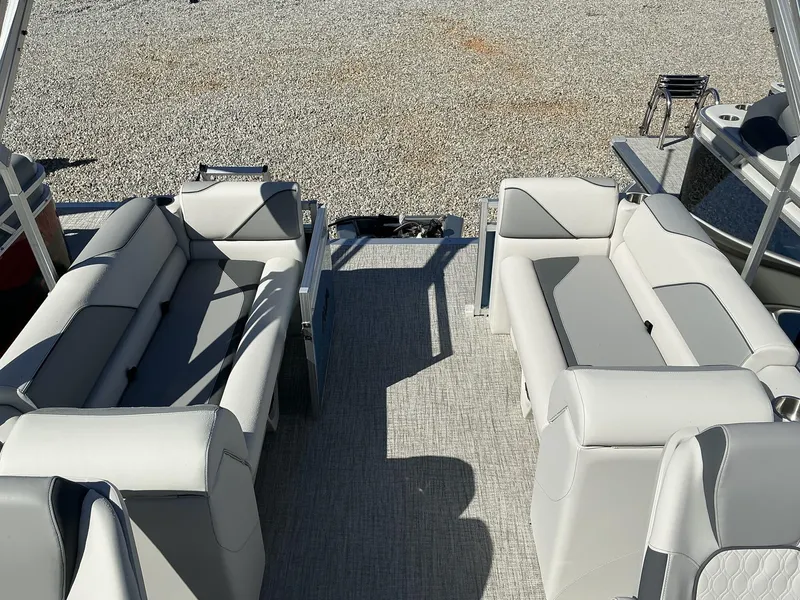 Slide: The Image of 2025 Avalon Venture 21 FT Quad Lounger with spacious seating on a gravel lot. - 5