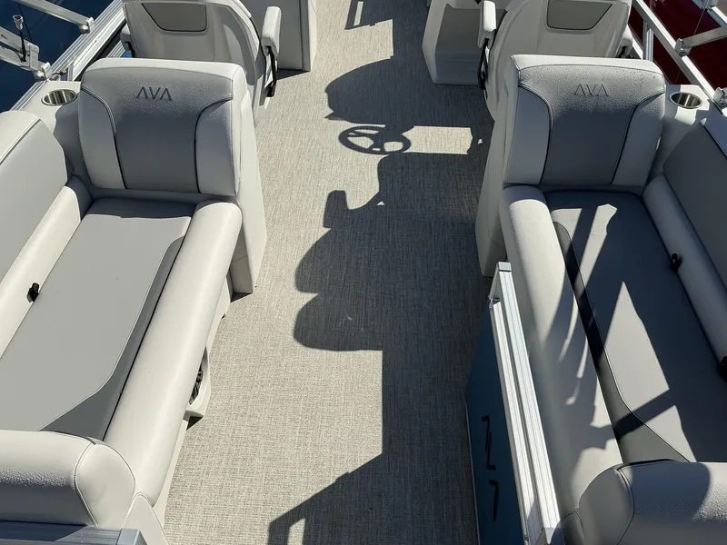 Slide: The Image of 2025 Avalon Venture 21 Quad Lounger interior with gray seating and steering wheel. - 8