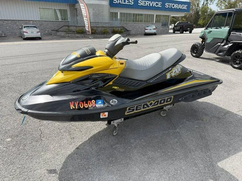 Slide: The Image of 2007 Sea-Doo RXP 215 jet ski in yellow and black, parked outdoors. - 1