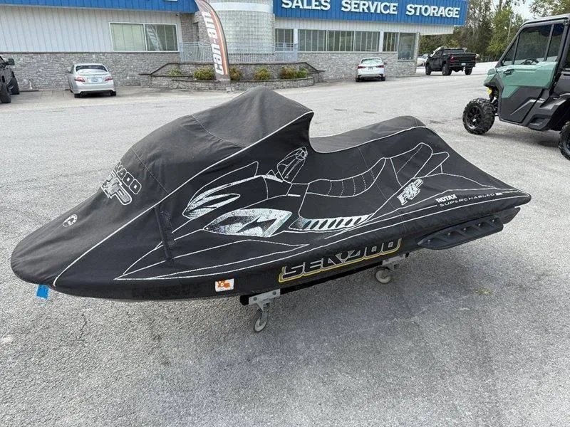 Slide: The Image of 2007 Sea-Doo RXP 215 jet ski covered, parked outside sales and service center. - 10