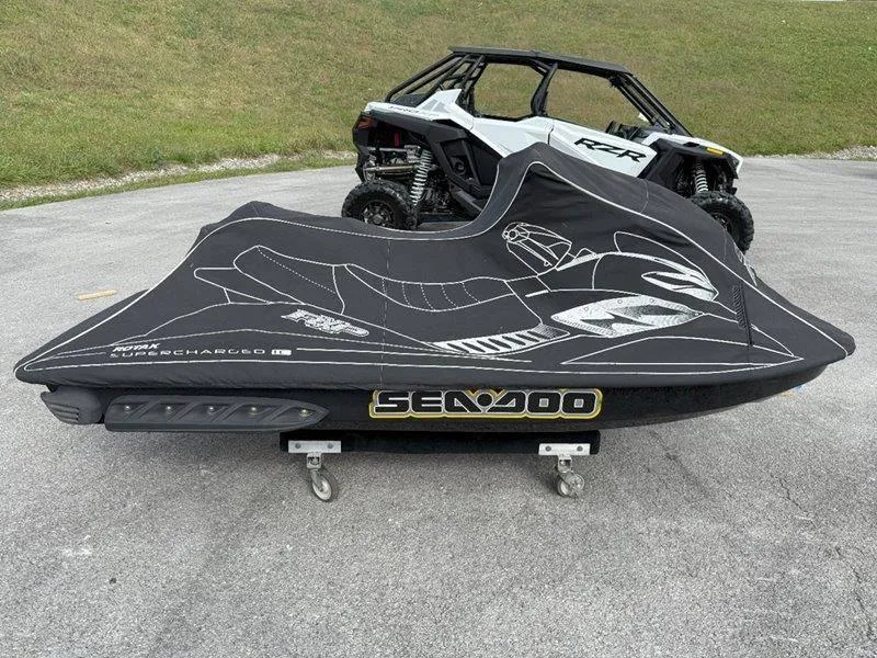 Slide: The Image of 2007 Sea-Doo RXP 215 jet ski covered, parked on pavement. - 11
